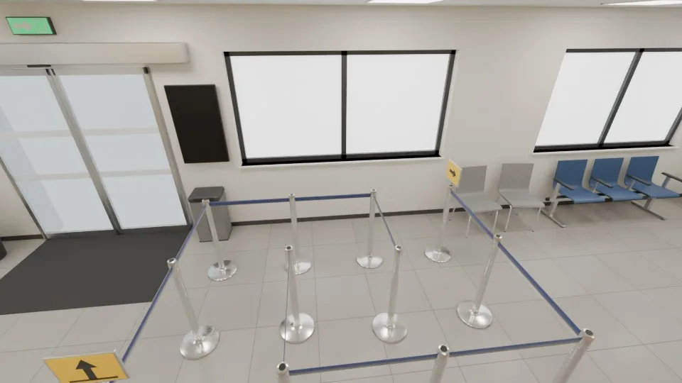 Looking from the counter toward the entrance: the queue posts with their belts and arrow signs. Each post is a separate object, and the belts attached to it follow when it is moved.